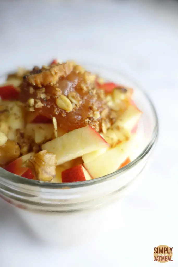 Spoonful of apple butter on top of fresh chopped apples and soaked oats.