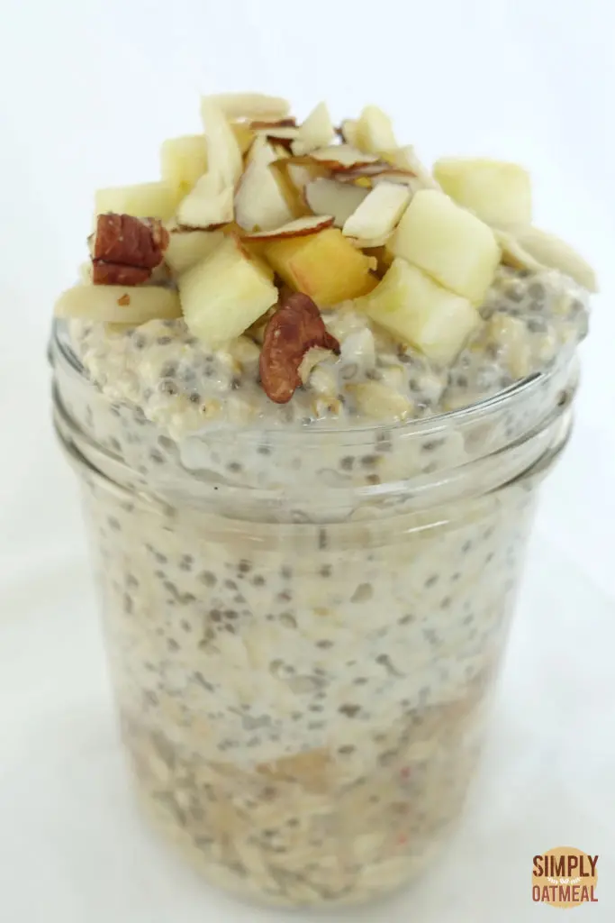 One serving of apple chia overnight oats in a tall mason jar.