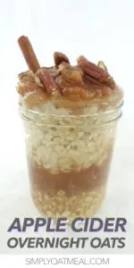 Mason jar filled with apple cider overnight oats. Topped with applesauce and chopped pecans.