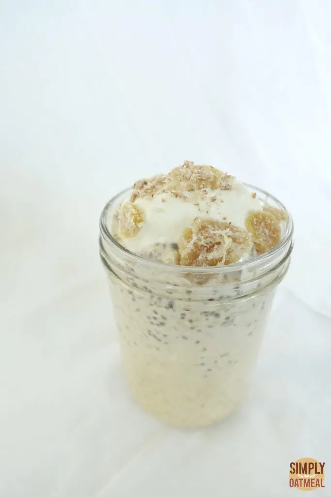 A serving of apple ginger overnight oats in a tall glass container.