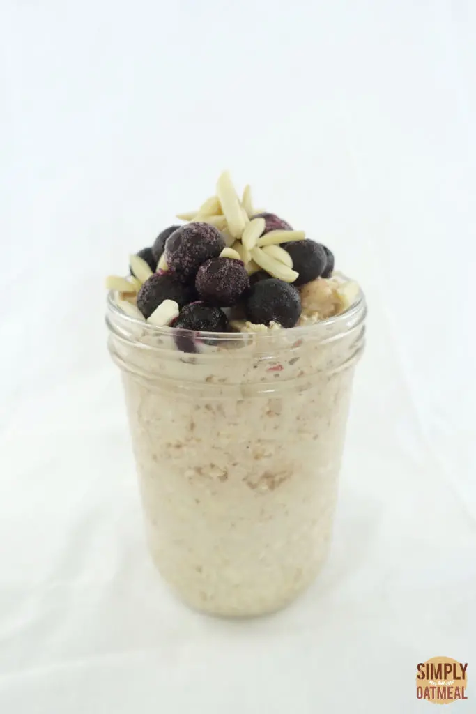 One serving of apple juice overnight oats in a glass container.