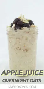 Apple juice overnight oats served in a tall mason jar and topped with blueberries and slivered almonds.