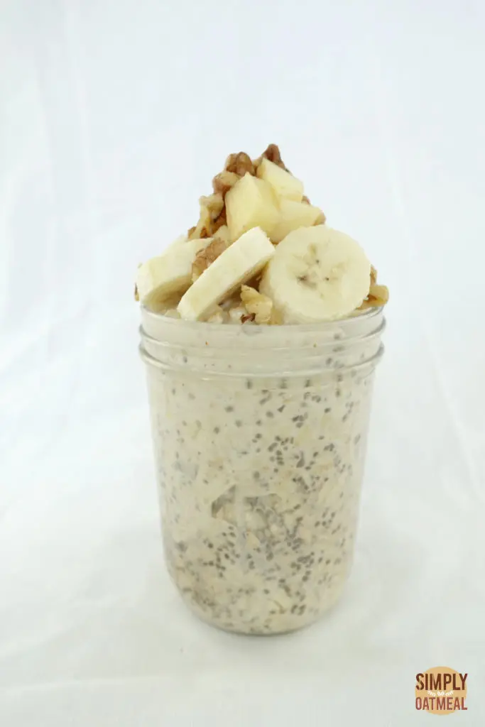 One serving of apple walnut overnight oats in a glass container.