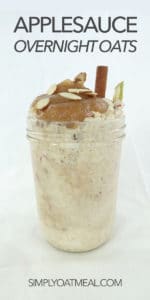 Applesauce overnight oatmeal served in a tall mason jar with a big scoop of homemade applesauce and a cinnamon stick garnish.