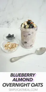 Glass container with one serving of blueberry almond overnight oats. The garnishes include almonds and fresh blueberries.