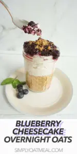 Blueberry cheesecake overnight oats in a jar with a spoon scooping one bite.