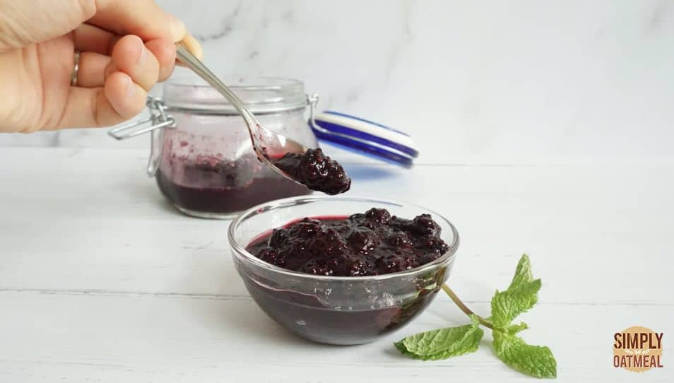 spoonful of blueberry chia jam from a small glass jar