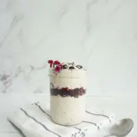 Mason jar with a single serving of blueberry coconut overnight oats.