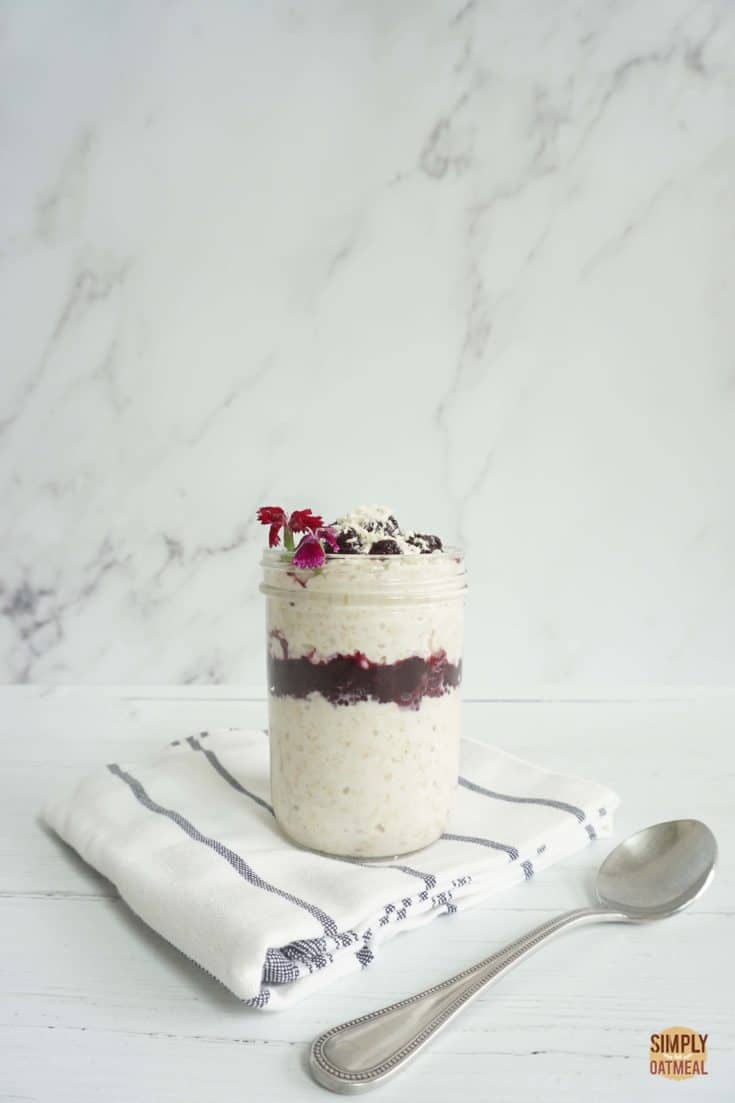 Mason jar with a single serving of blueberry coconut overnight oats.