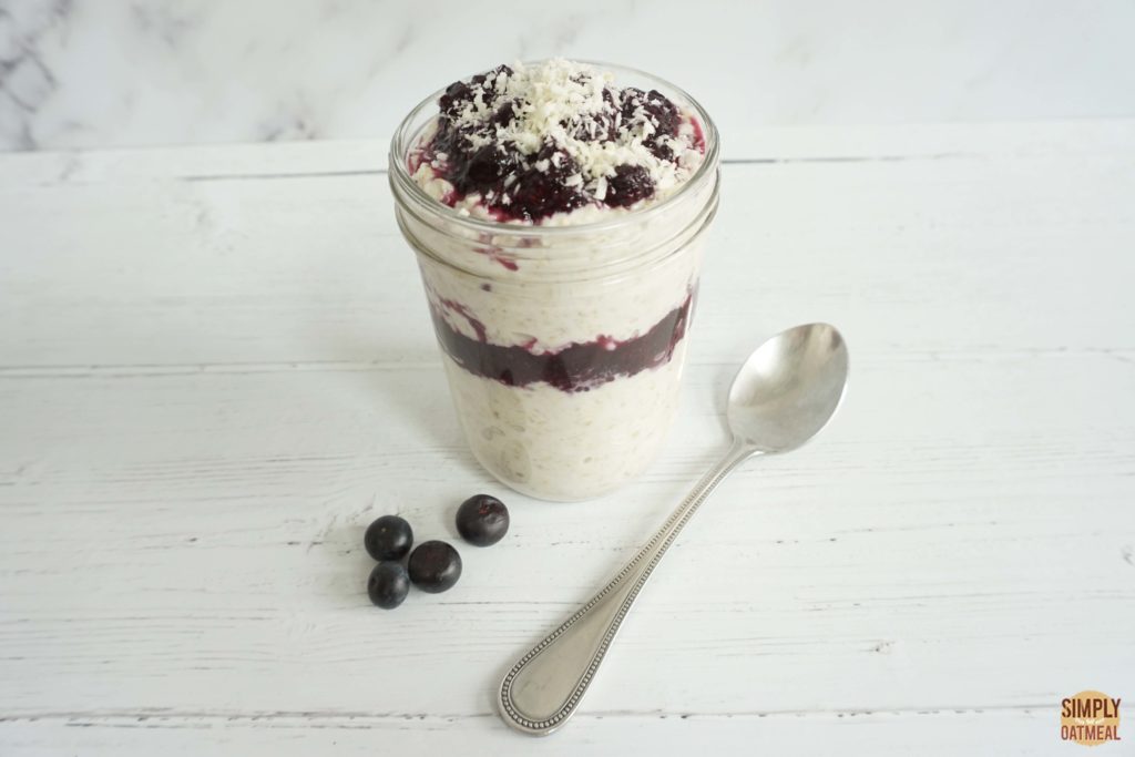 One serving of blueberry coconut overnight oats in a glass jar