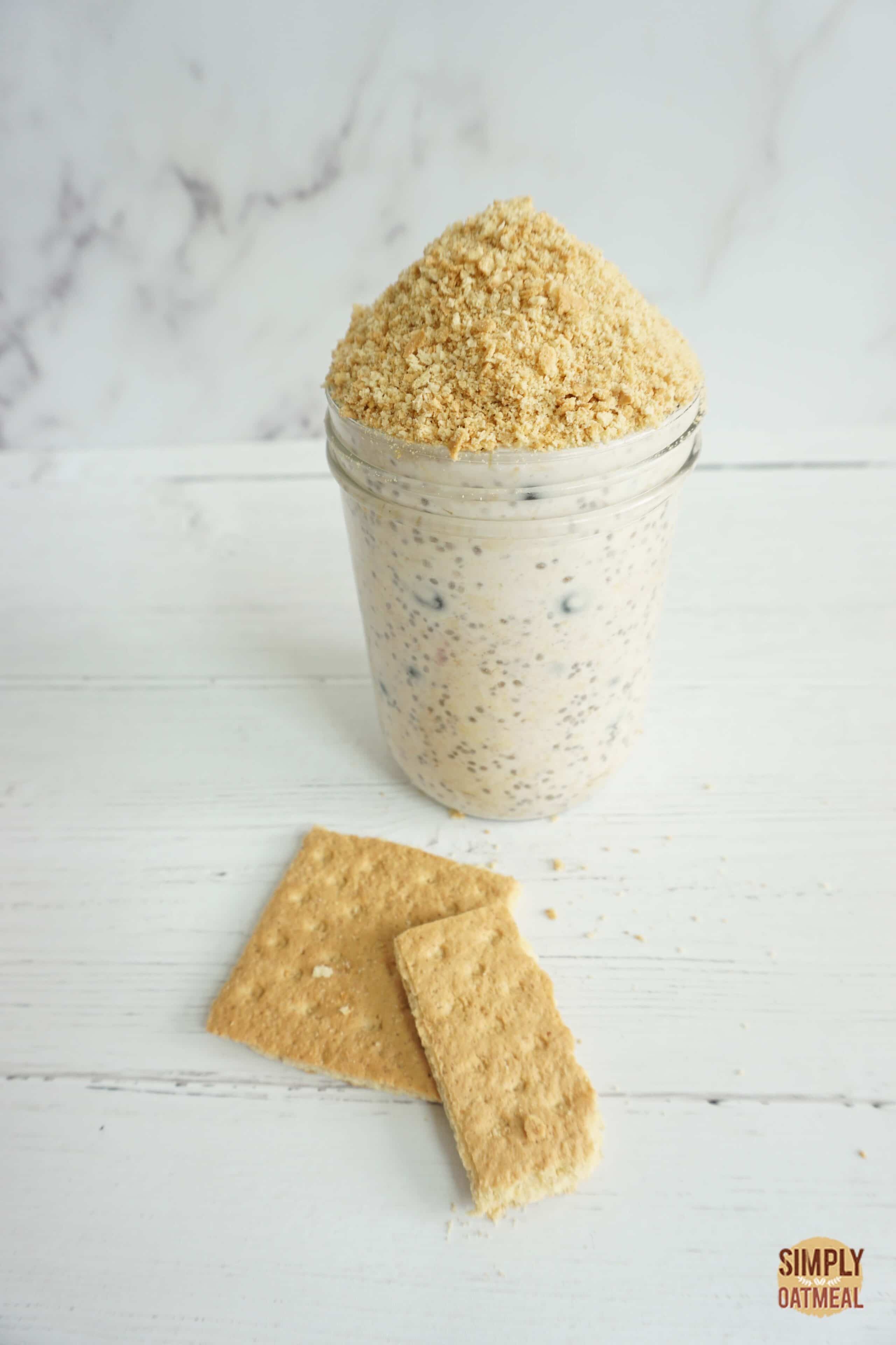 Single serving of blueberry Greek yogurt overnight oats served with crushed graham crackers on top