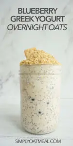 Blueberry Greek yogurt overnight oats look creamy and delicious in a glass container.