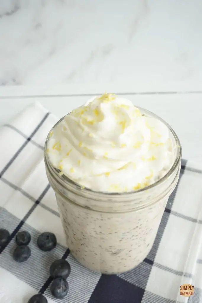 Bowl of blueberry lemon overnight oats topped with fresh lemon zest