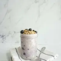 Single serving of blueberry pie overnight oats in a mason jar.