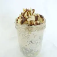 Single serving of caramel apple overnight oats in a tall glass container.