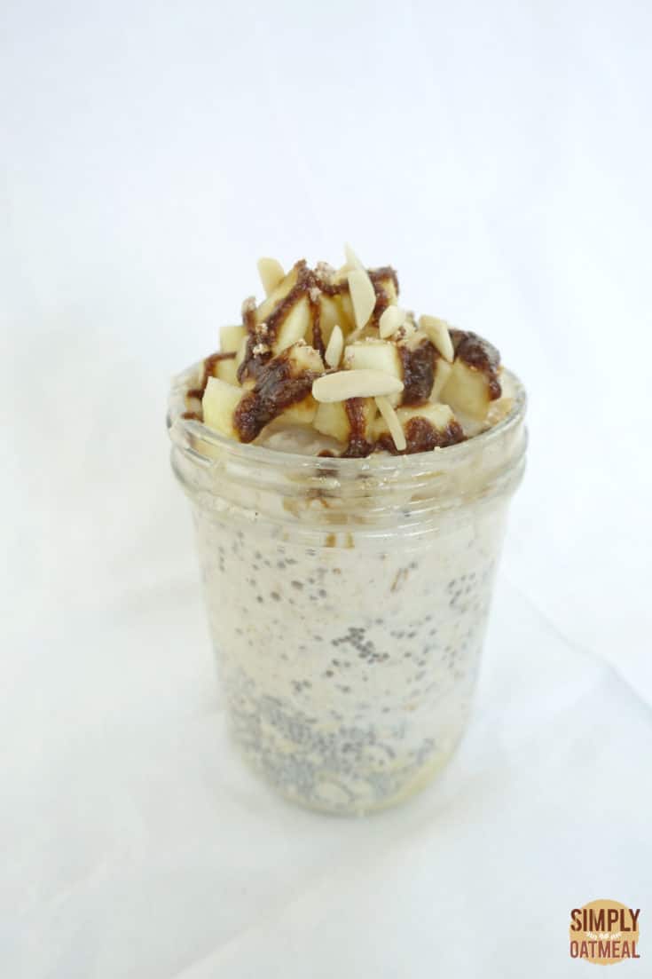 Single serving of caramel apple overnight oats in a tall glass container.