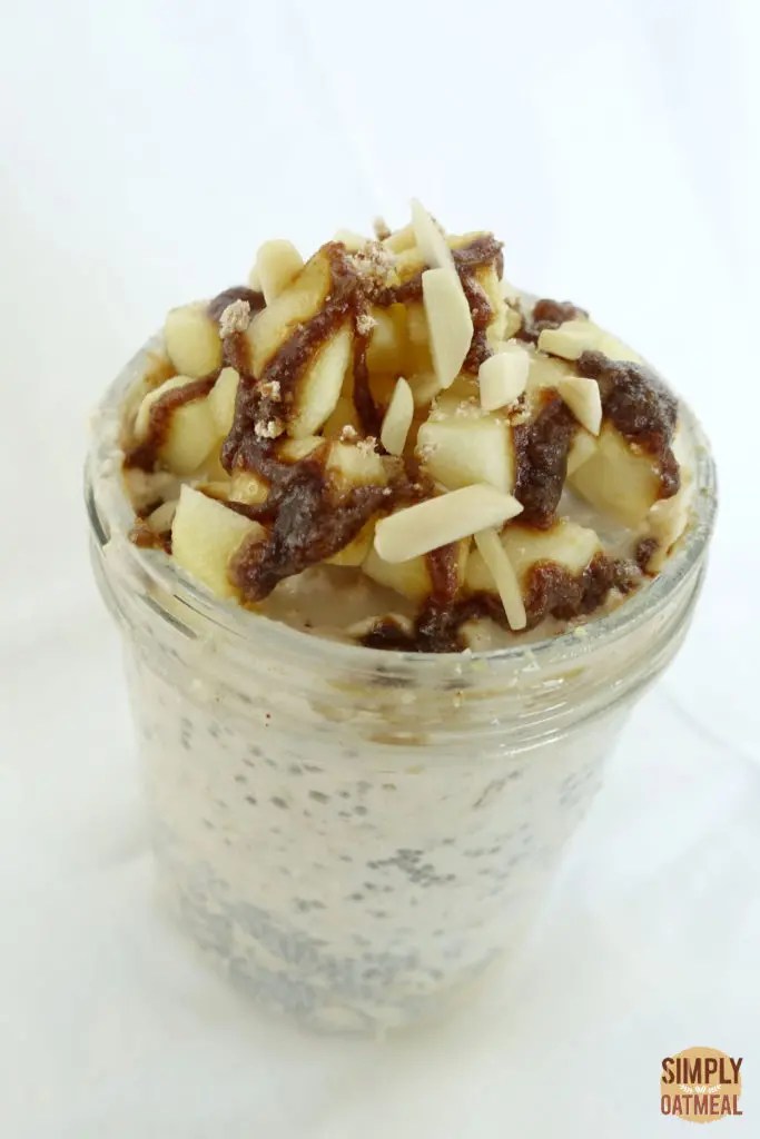 Caramel apple overnight oats served in a glass jar.