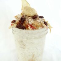 Single serving of grated apple overnight oats in a tall mason jar.
