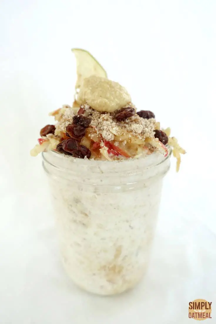 Single serving of grated apple overnight oats in a tall mason jar.