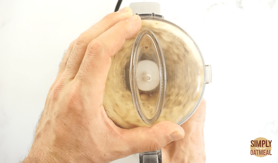peanuts being ground up inside food processor