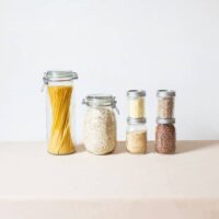 Oats and other dry goods stored in glass containers.