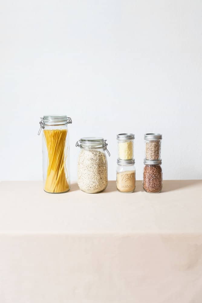 Oats and other dry goods stored in glass containers.