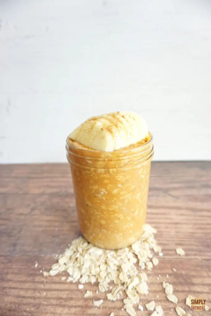 Tall mason jar filled with single serving of pumpkin apple overnight oats