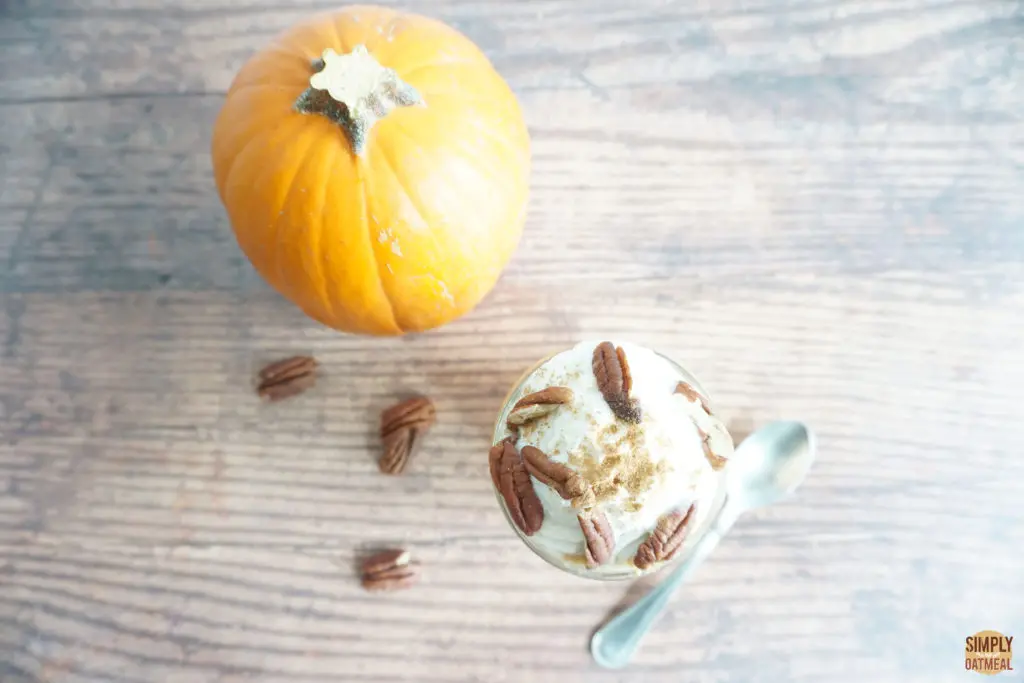 pumpkin pie overnight oats in a small bowl next to a whole sugar pie pumpkin