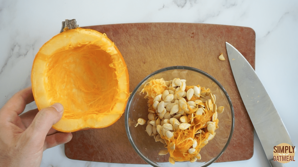 Scoop out the pumpkin seeds and remove the stringy flesh.
