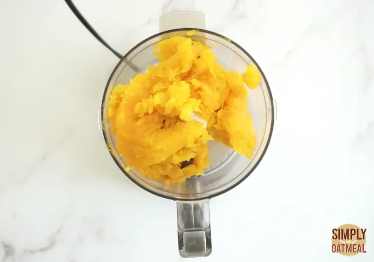 scoop roasted pumpkin into a food processor to make puree. Puree pumpkin until extra smooth.