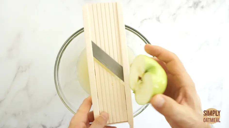 Slice apple using mandoline to make consistent even apple chips