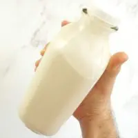 soy milk in a glass bottle ready to go inside the refrigerator