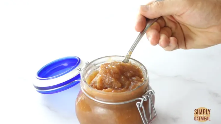 spoonful of applesauce from glass jar