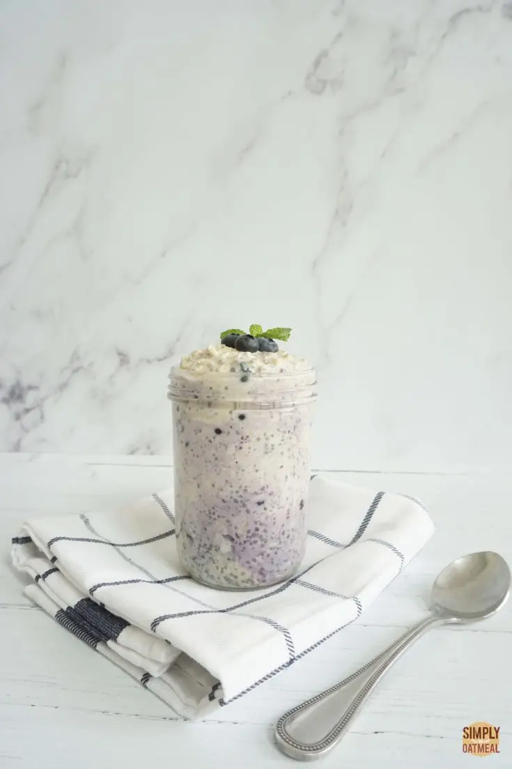Mason jar filled with single serving of vegan blueberry overnight oats