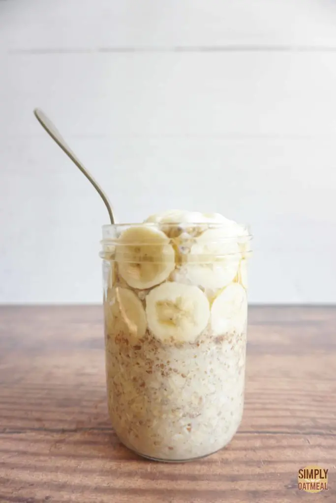 One serving of banana honey in an overnight oats container with a spoon sticking out