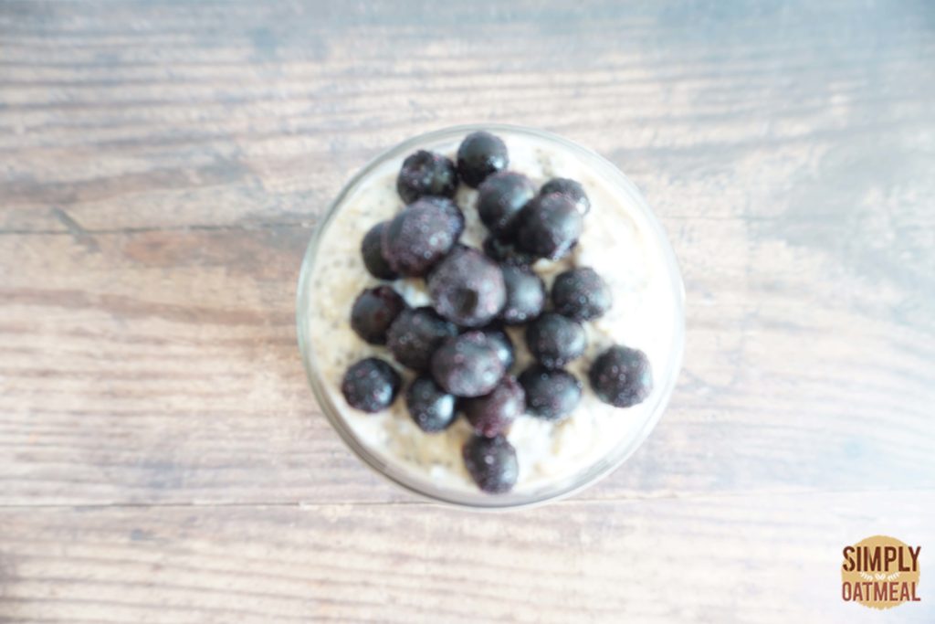 Blueberry banana overnight oats topped with a scoop of yogurt and fresh blueberries.