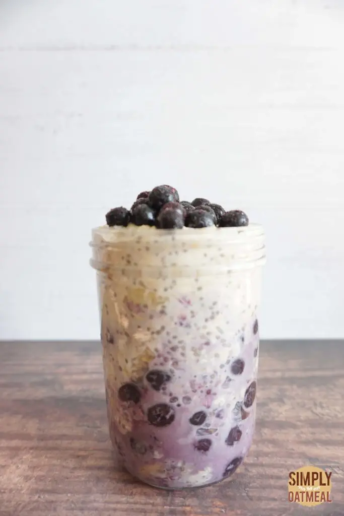 Blueberry banana overnight oats served in a tall glass jar