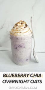 One serving of blueberry chia overnight oats garnished with whipped cream and cinnamon spice.