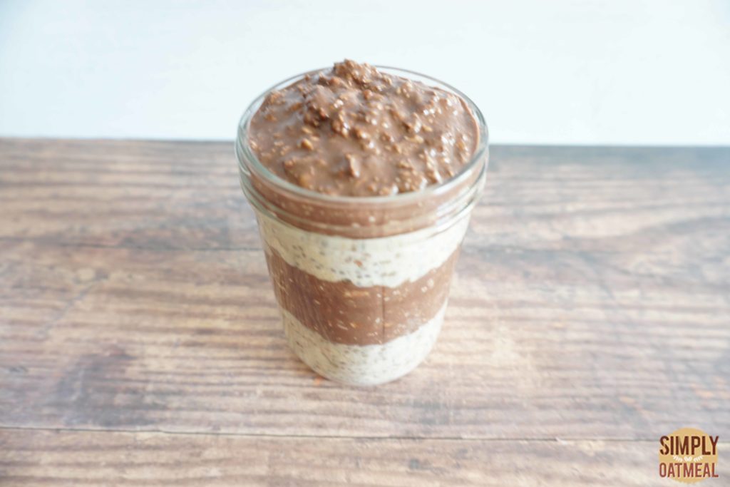 Chocolate peanut butter banana overnight oats topped with warm chocolate sauce