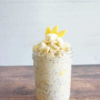 Mango banana overnight oats served in a glass meal prep container.