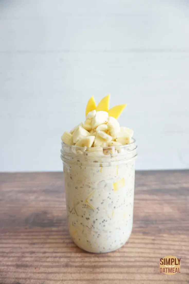 Mango banana overnight oats served in a glass meal prep container.