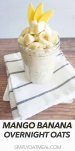 One serving of mango banana overnight oats topped with a pile of fresh chopped banana and mango.
