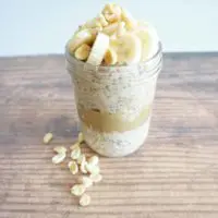 Overnight oats layered with peanut butter and sliced banana on top.
