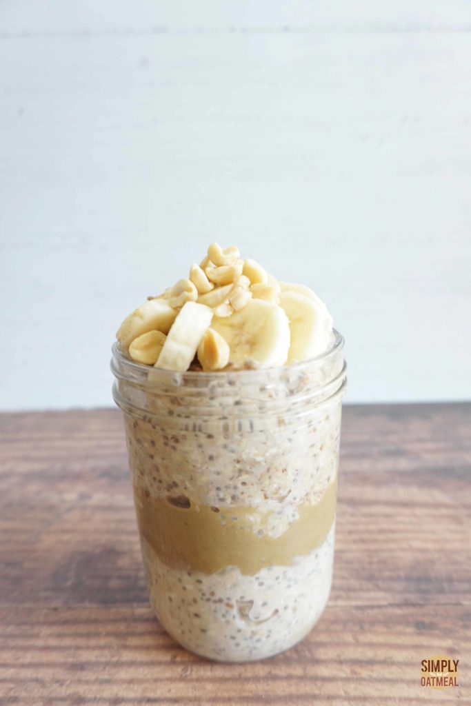 Peanut butter banana overnight oats in a tall glass container.
