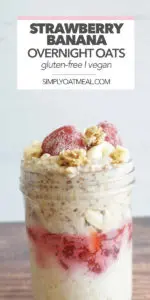 Closeup of strawberry banana overnight oats in a glass bowl with fresh strawberries and banana slices