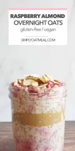 Raspberry almond overnight oats served in a mason jar with raspberries and sliced almonds on top.