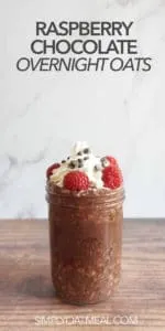 One serving of raspberry chocolate overnight oats in a mason jar