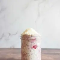 Single serving of raspberry coconut overnight oats in a mason jar