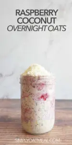 One serving of raspberry coconut overnight oats in a tall glass jar.