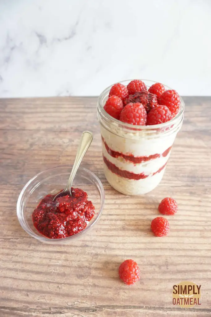 Raspberry jam overnight oats with raspberry chia jam and fresh raspberries on the side